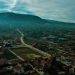 an aerial view of a town with mountains in the background